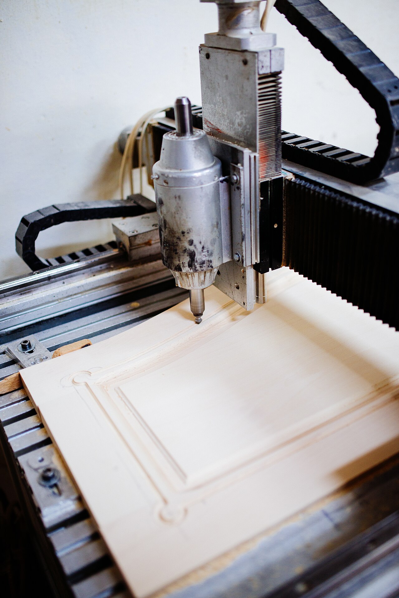 CNC machining center finishing a sintered metal injection molding part during secondary operations