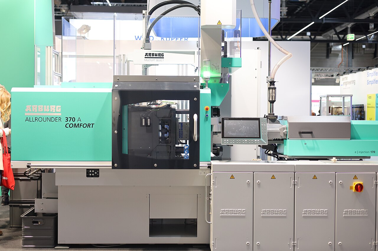 MIM injection molding machine where gate and runner design sets green density and fill balance